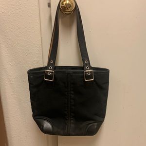COACH black handbag with satin tan signature lining.